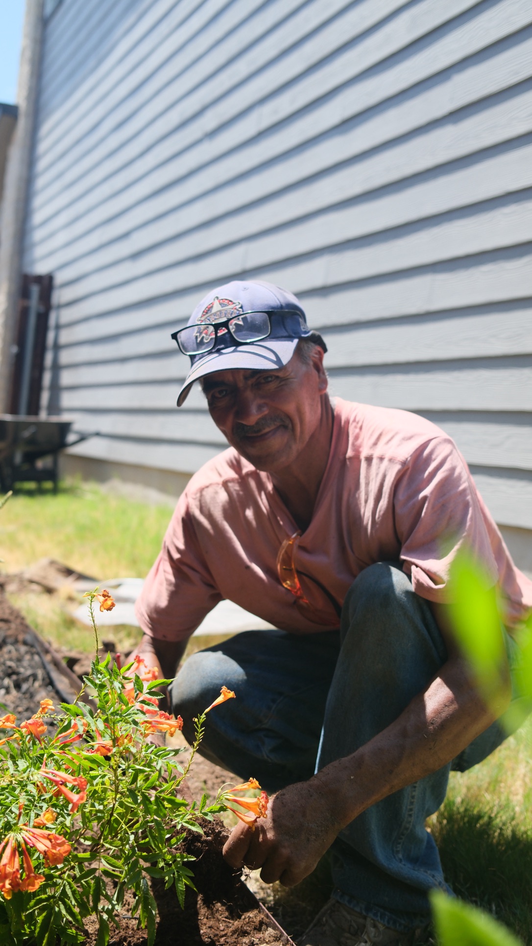 Full portrait of Gonzalo Sr. working among flowering plants