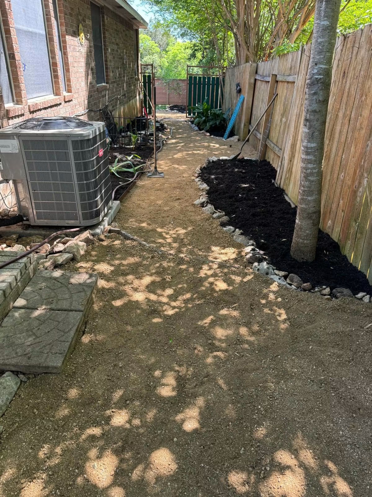 Residential side yard after compacted-path construction and mulching